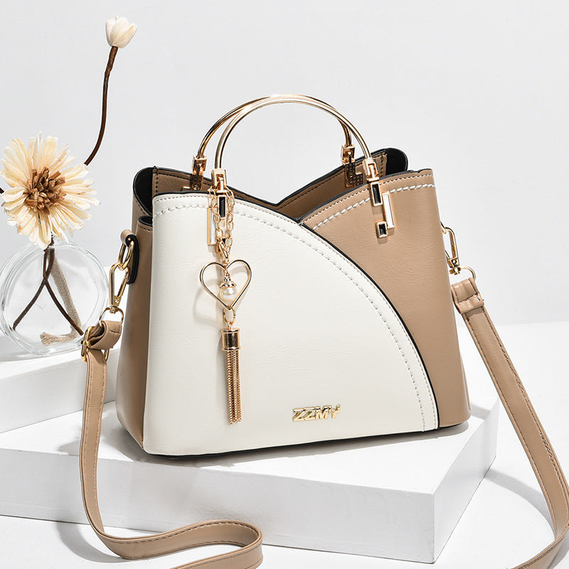 Chic Contrast: Signature Two-Tone Shoulder Bag with Heart Charm Accent Feminé Luxé