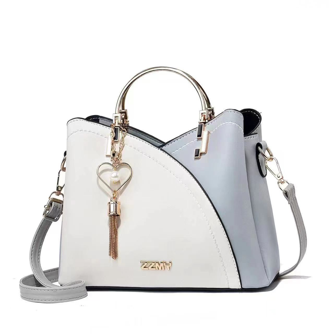 Chic Contrast: Signature Two-Tone Shoulder Bag with Heart Charm Accent Feminé Luxé