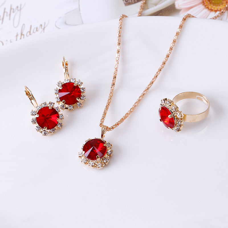 Chic Euro-American Round Crystal Jewelry Set: Sapphire/Ruby Solitaire Necklace, Drop Earrings & Ring Trio Feminé Luxé