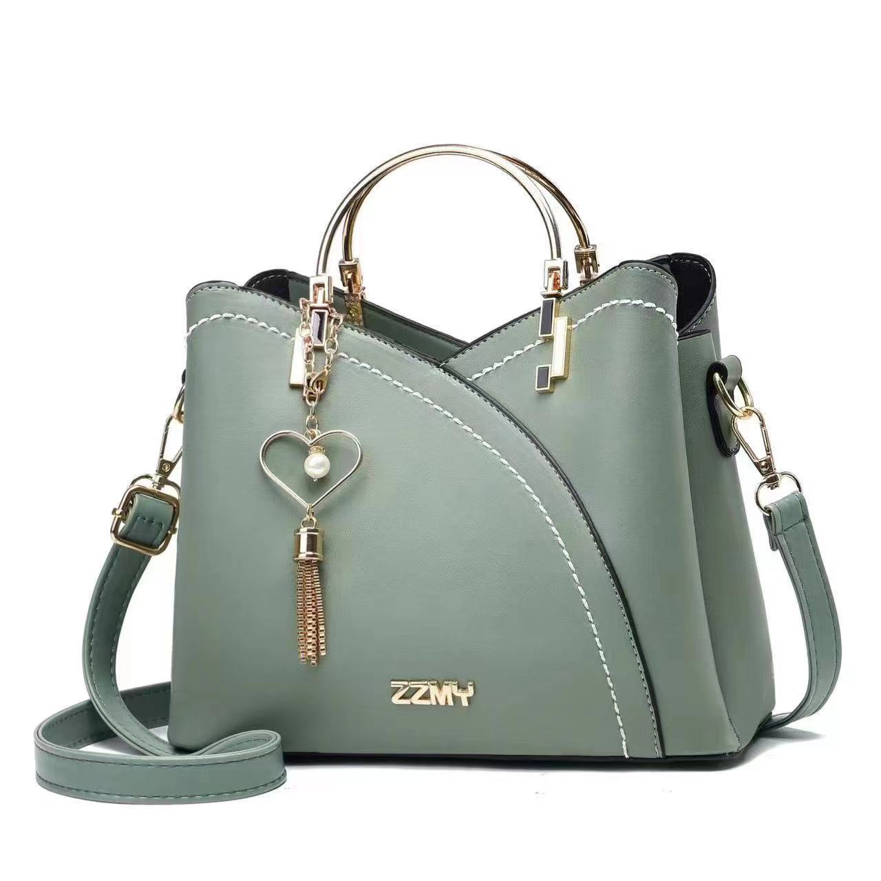 Chic Contrast: Signature Two-Tone Shoulder Bag with Heart Charm Accent Feminé Luxé