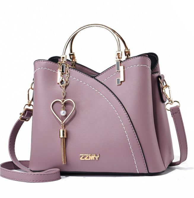 Chic Contrast: Signature Two-Tone Shoulder Bag with Heart Charm Accent Feminé Luxé
