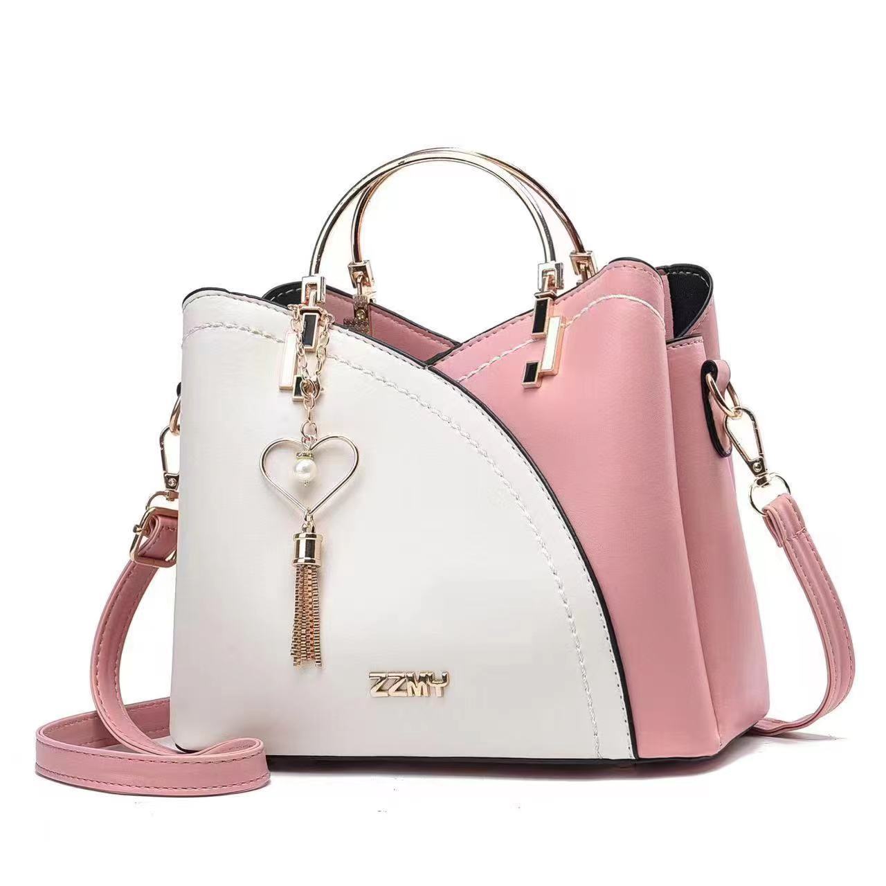 Chic Contrast: Signature Two-Tone Shoulder Bag with Heart Charm Accent Feminé Luxé